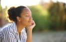 Black relaxed woman resting in a park
